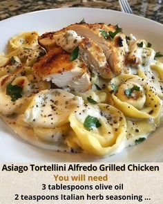 a white plate topped with pasta and chicken