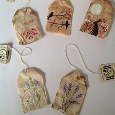 six tags with flowers and birds on them are hanging from twine strings in the shape of hearts