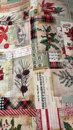 a quilted table cloth with red and green flowers on it's edges, surrounded by other fabric material