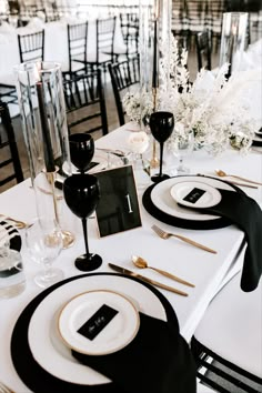 the table is set with black and white place settings