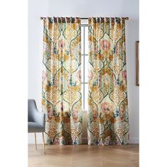 the curtains are open and ready to be hung in front of a window with an ornate pattern