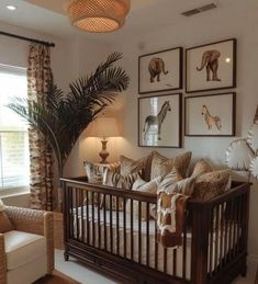 a baby's room with zebras and giraffes on the wall