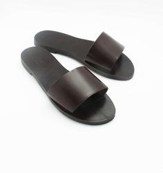 Casual slip on sandals, lightweight but durable.- Pictured in dark chocolate brown color.- Leather straps available in 19 colors. See 3th image for the color chart.- Premium quality dark chocolate brown leather insole.- Anti-slippery EVA out sole.- 0.27" heel.Please contact me in case you have narrow or wide feet.SIZESPlease watch the video (copy & paste the link below to your browser) in order to follow the instructions on how to measure your feet. Or visit the last image of this listing.https: Cheap Brown Slides With Textured Footbed, Luxury Brown Slides With Flat Heel, Luxury Brown Slip-on Slides, Luxury Brown Open Toe Slippers, Cheap Summer Brown Slides, Luxury Brown Flat Slides, Cheap Brown Slide Sandals, Luxury Brown Slides With Textured Footbed, Luxury Brown Slides With Single Toe Strap