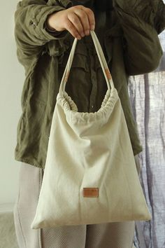 a woman holding a white bag in her hands