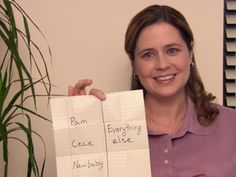 a woman holding up two pieces of paper with writing on it and smiling at the camera