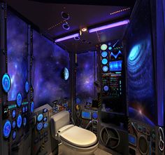 a toilet sitting in the middle of a room filled with space themed walls and lights