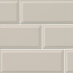 a white brick wall that is very close to the ground