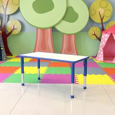 a child's playroom with colorful carpet, trees and tent in the background