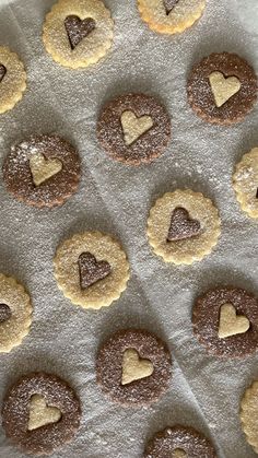 cookies are arranged in the shape of hearts on a baking sheet