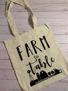 Farm to Table tote bag Measures 15.5"H x 13.5"W x 4"D Handles 26"L Made of 100% cotton This tote bag is perfect for your local farmer's market trip or just every day carrying! The tote bag is canvas with HTV black lettering. Cotton Tote Canvas Bag For Market, Cotton Canvas Tote Bag For Market, Eco-friendly Cotton Bags For Farmers Market, Local Farmers Market, Farm To Table, The Tote Bag, Farmer's Market, Canvas Tote, Every Day