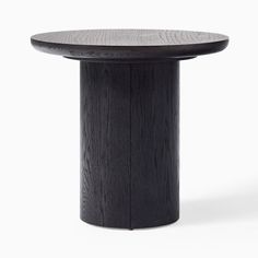 a round wooden table with black wood grain on the top and white backround