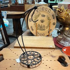 a wooden table topped with lots of different types of furniture and decor items on top of it