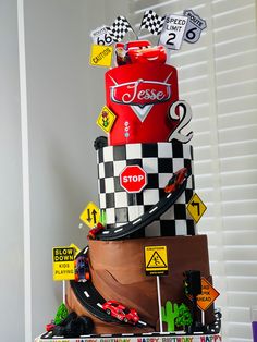 a cake made to look like a race car on top of a stack of cars