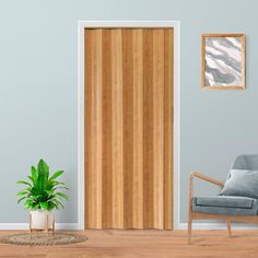 a living room with a chair, potted plant and wooden sliding door in it