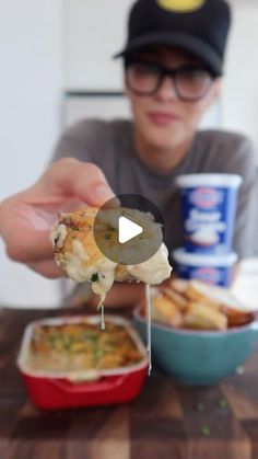 a person is eating some food on a stick with toothpicks in front of them