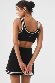 Cut from a softly textured cotton knit with a slew of preppy details, this bra top brings a touch of tenniscore to any look. It has a lightly supportive fit with tank straps, a classic scoop neck, and a scooped-low back. And as for that cute, contrasting trim? It pairs perfectly with the rest of the Tennis Club collection. Sporty Ribbed Crop Top For Loungewear, Alo Yoga Ribbed Athleisure Top, Sporty Bra-friendly Activewear By Alo Yoga, Sporty Tank Top With Contrast Trim, Sporty Medium Support Crop Top For Everyday Wear, Casual Seamless Tops By Alo Yoga, Sporty Everyday Crop Top With Seamless Construction, Alo Yoga Fitted Sporty Tank Top, Sporty Seamless Alo Yoga Tops