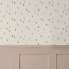 the wallpaper is white and has small flowers on it