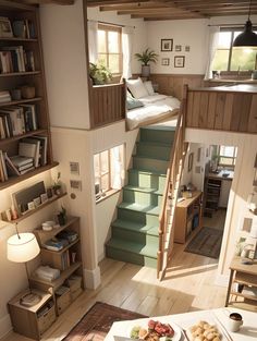 a living room with stairs leading up to the bedroom and dining area in front of it