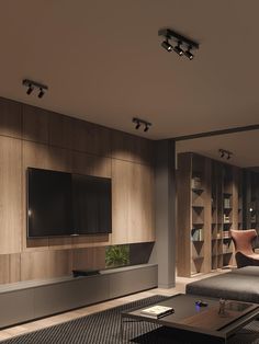 a living room filled with furniture and a flat screen tv mounted to the side of a wall