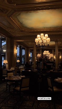 a fancy restaurant with chandeliers and tables