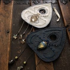 two pieces of cloth and metal on top of a wooden table next to other items