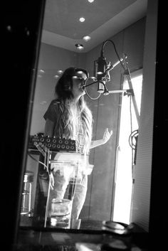 a woman standing in front of a microphone