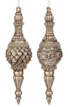 two silver vases sitting side by side on top of each other, one with an ornate design