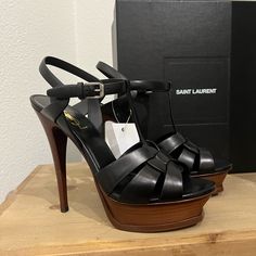 Brand New In Box. No Sign Of Wear. New With Tags. Saint Laurent Interwoven Leather Sandal. T-Bar Front And Oversized Platform Ensure They Exude A 1970s-Meets-Modern-Day Aura, No Matter What You Pair Them With. 4.1" Covered Stiletto Heel; 1.2" Platform; 3.1" Equiv. Tapered Straps Band Open Toe. T-Strap Vamp. Adjustable Ankle Strap. Leather Lining And Sole. High-end Leather Open Toe Heels, High-end Open Toe Leather Heels, Designer Platform Heels With Open Heel, Designer Open Heel Platform Heels, Designer High Heels With Heel Strap, High-end Open Toe Heels With Branded Heel Counter, High-end Leather Party Heels, Black Strappy High Heels, Strappy High Heels Sandals