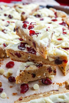 several pieces of cake with cranberry toppings stacked on top of each other