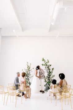 the bride and groom are getting married in front of their guests at this wedding ceremony