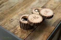 three wood slices with the initials mr and mrs on them sitting on a wooden table