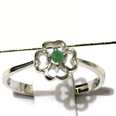 0.05ct Genuine Emerald in .925 Sterling Silver Flower Ring Size 7 Metal Information:  .925 Sterling Silver  Total CW : 0.05 cts Weight: 1.60 Grams Stone Information:  Emerald   Quantity / Weight: 1/0.05cts  Shape / Size: Round/2.30mm Silver Flower Ring, Tanzanite Ring, Message Jewelry, Sterling Silver Flowers, Ruby Ring, Pink Diamond, Silver Flowers, 925 Sterling Silver Ring, Promise Rings