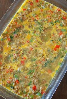 a casserole dish with meat and vegetables in it on a wooden table top