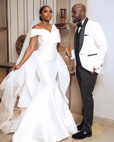 a man and woman in formal wear standing next to each other