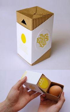 two eggs in a box are being held by someone's hand and the other is open