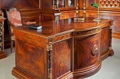 an elegant wooden desk and chair in a room