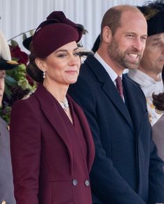 two men and a woman are sitting next to each other in front of some people