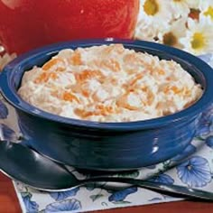 a bowl filled with oatmeal sitting on top of a table next to an apple