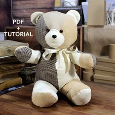 a teddy bear sitting on top of a wooden table next to books and other items