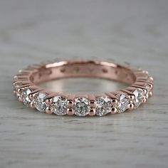 a rose gold wedding band with five diamonds