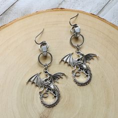 These dragon earrings are the perfect witchy emo jewelry! They would make a great dragon lover gift or metalhead gifts! These silver goth men earrings would also make a great Mother's Day gift from a daughter.  This is a pair of lovely dragon earrings that I made using metal alloy dragon pieces, hypoallergenic surgical steel ear wires, stainless steel hex bolts, and stainless steel jump rings.  Earrings are made with nickel and lead free ear wires.  All orders ship the next business day.  ...... Earrings Emo, Goth Men, Earrings Dragon, Emo Jewelry, Witchy Earrings, Earrings Men, Goth Guys, Goth Earrings, Dragon Earrings