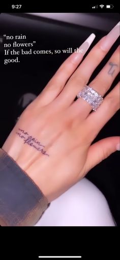 a woman's hand with a ring on it and an inscription written in the middle