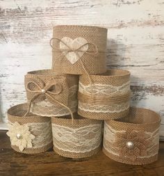 several baskets are stacked on top of each other, with bows and pearls in them