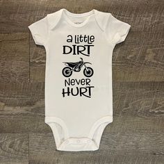 A Little Dirt Never Hurt This listing is for one (1) white bodysuit with black vinyl on the front. Available in short sleeve.  Available Sizes:  Newborn 3 Month 6 Month 9 Month 12 Month 18 Month I hand make each bodysuit, no two will be exactly the same, please allow 3-7 days for production. Please email me with any questions.  Want to see more, check us out on Facebook at http://www.facebook.com/williamandwesley and Instagram @williamandwesleyapparel Thank you for shopping! Track Motorcycle, Dirt Track, Cotton Bodysuit, White Bodysuit, Boy Baby, Black Vinyl, Future Baby, Dirt Bike