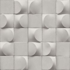 a wall made up of white tiles with circles