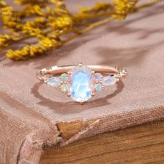 an opal stone ring sits on top of a book