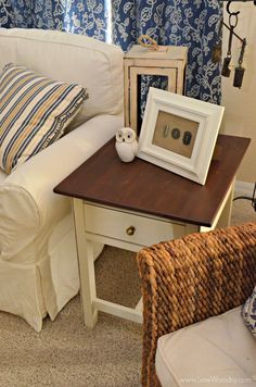 a white couch sitting next to a wooden table