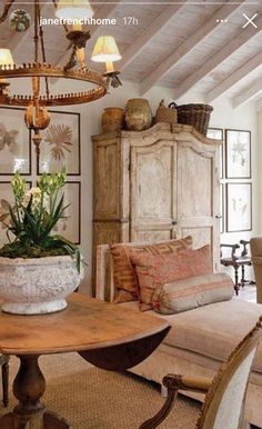 a living room filled with furniture and a chandelier