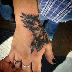 a woman's hand with a tattoo on it