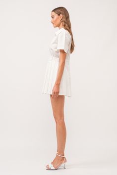 The White Romper Dress is a versatile addition to any wardrobe. Made from 100% cotton, this dress features a stylish wrap design, a pleated skirt, and a classic collar. With its mini length, it is perfect for both casual and formal occasions. Stay comfortable and chic in this must-have dress. collared wrap style romper dress (shorts built in) hand wash cold / line dry model is 5'11" and is wearing a size small Classic Pleated Knee-length Mini Dress, Classic Knee-length Pleated Mini Dress, Fitted Cotton Mini Dress With Pleats, Classic Mini Pleated Skirt For Work, Workwear Mini Pleated Skirt With Pleated Hem, Chic Mini Dress With Pleated Hem For Daywear, Classic Cotton Mini Pleated Skirt, Classic Cotton Pleated Mini Skirt, Elegant Pleated Cotton Mini Dress